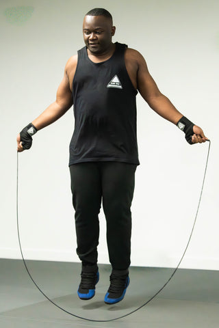 Adult student skipping rope during a conditioning warm-up at One Way Martial Arts in Alexandria, VA