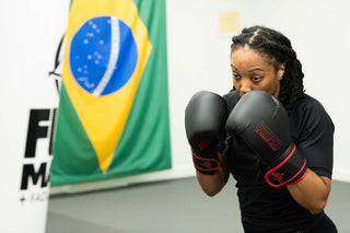 Boxing student in guard stance with gloves at One Way Martial Arts in Alexandria, VA