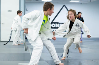 Coach running a drill with kids in the Kids BJJ class at One Way Martial Arts in Alexandria, VA
