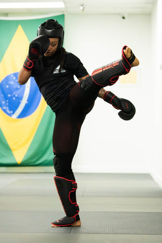 Muay Thai student throwing a high kick at One Way Martial Arts in Alexandria, VA
