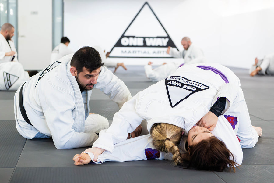 Coach Patrick Almeida teaching a BJJ technique in the gi at One Way Martial Arts