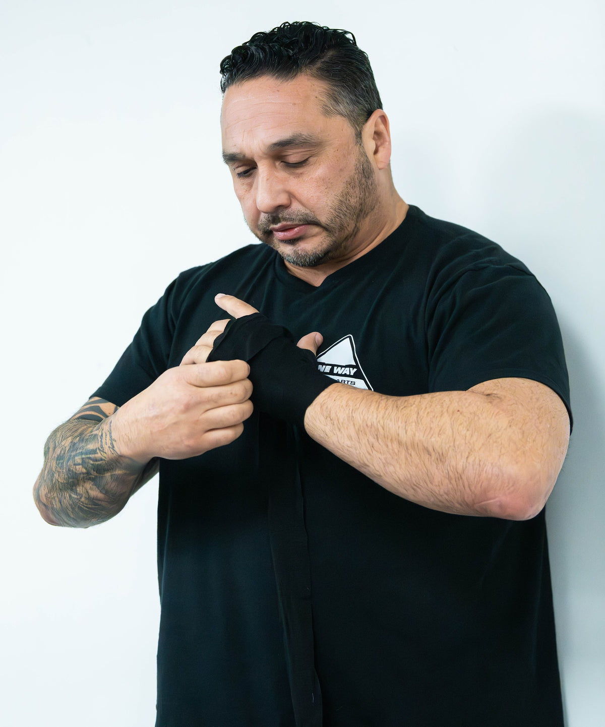 Striking coach wrapping his hands before class at One Way Martial Arts in Alexandria, VA