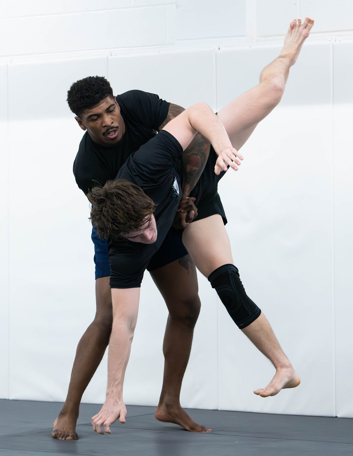 No-Gi student lifting a partner for a takedown at One Way Martial Arts in Alexandria, VA