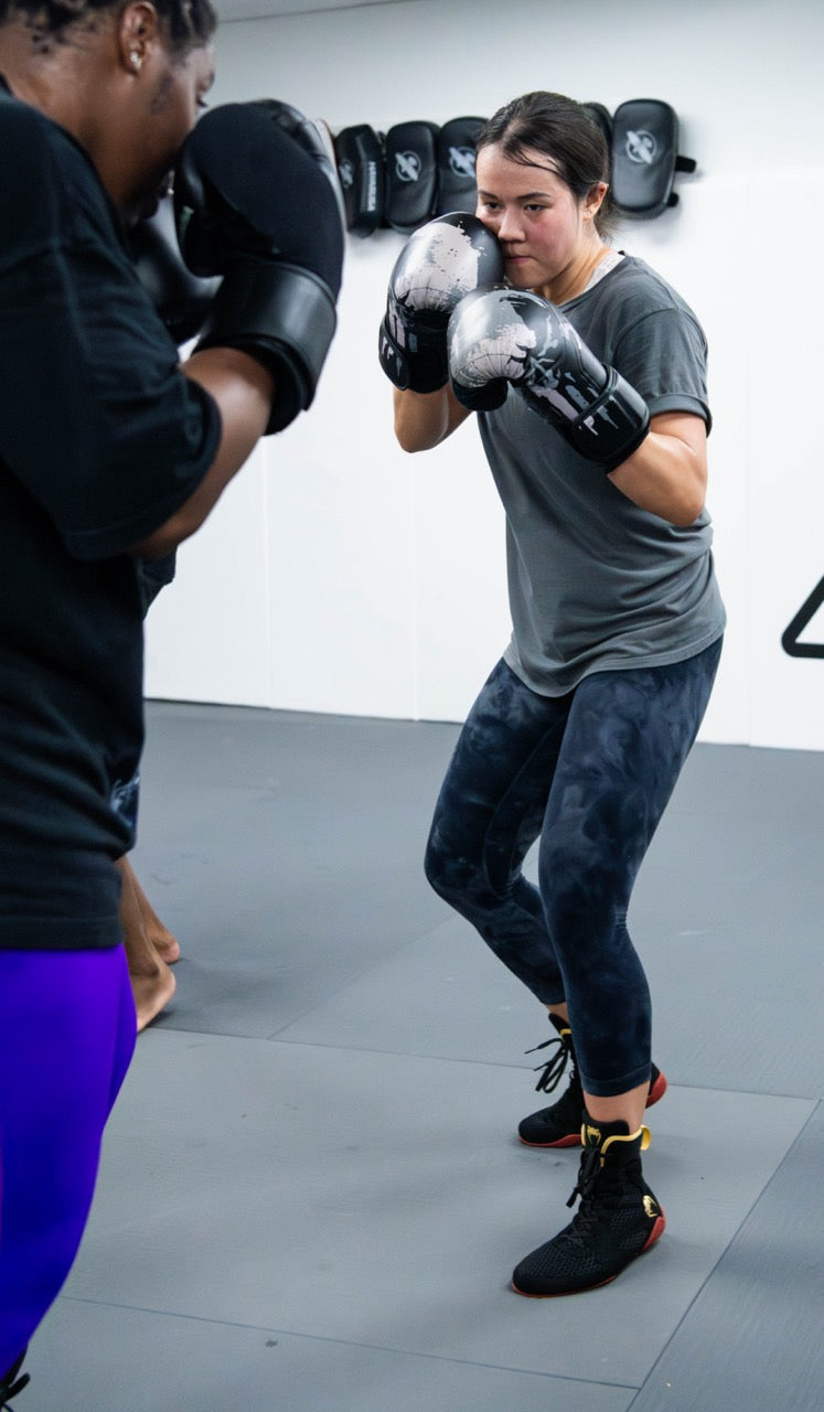 Boxing student shadowboxing in gloves at One Way Martial Arts in Alexandria, VA