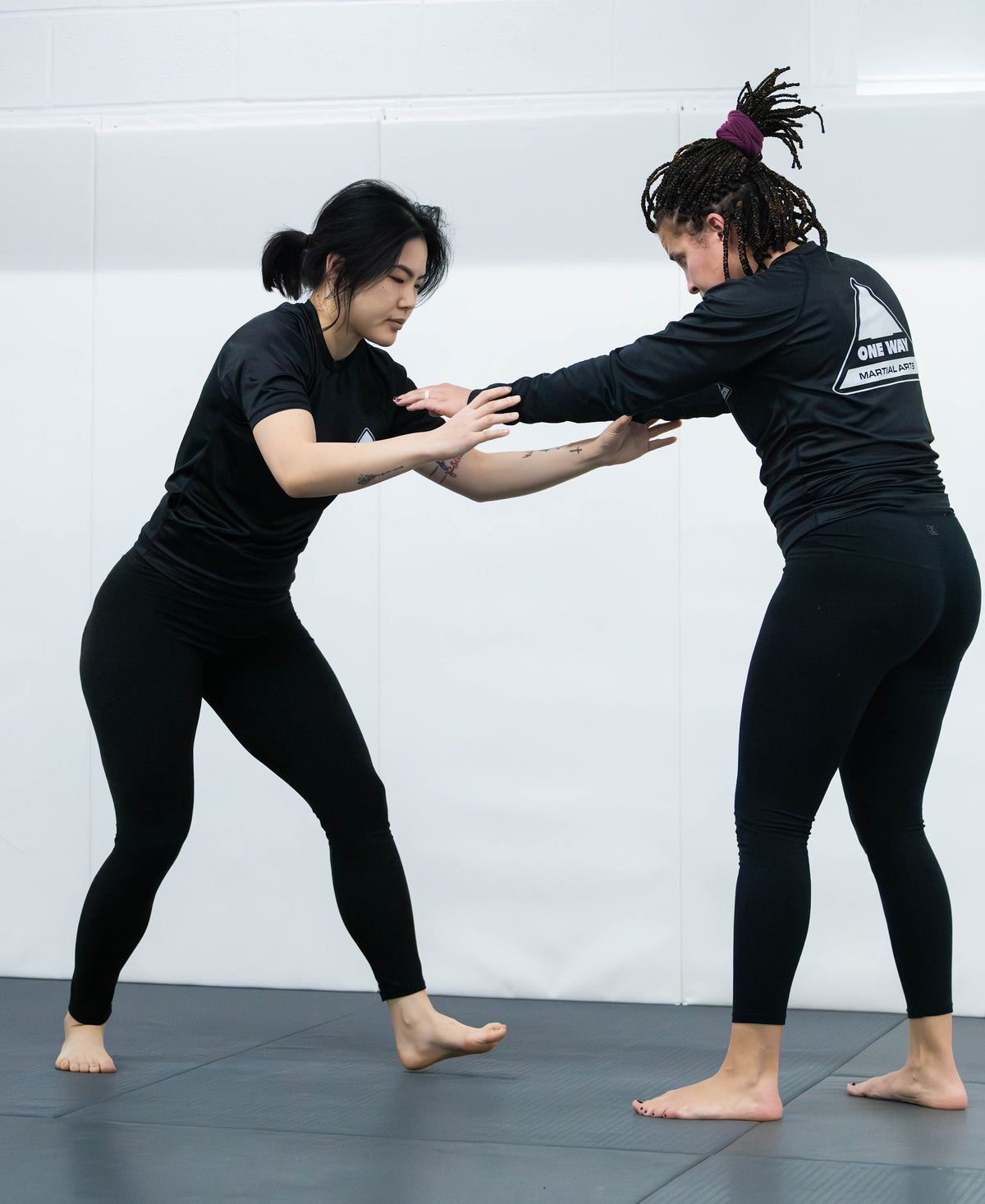 Two women drilling No-Gi grappling hand fighting at One Way Martial Arts in Alexandria, VA