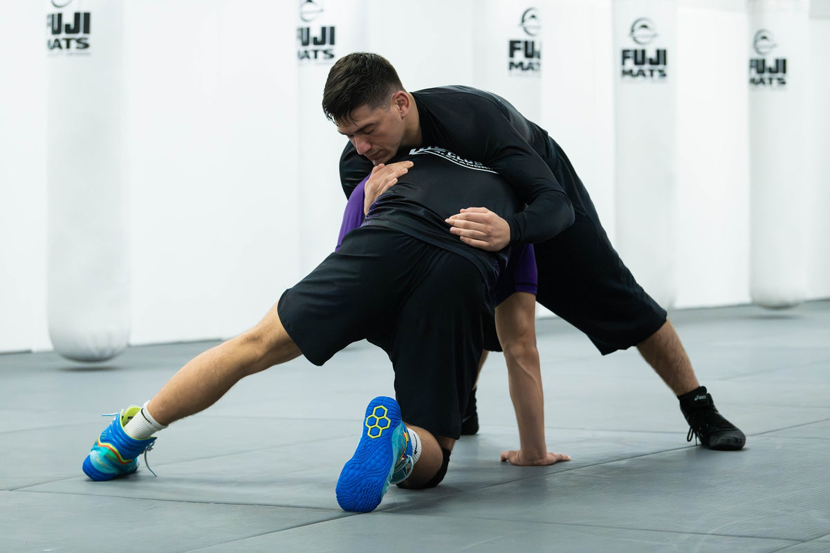 Wrestler shooting a single leg takedown in wrestling class at One Way Martial Arts in Alexandria, VA