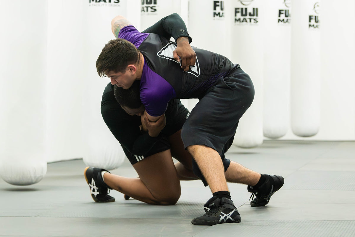 Wrestler finishing a takedown in wrestling class at One Way Martial Arts in Alexandria, VA